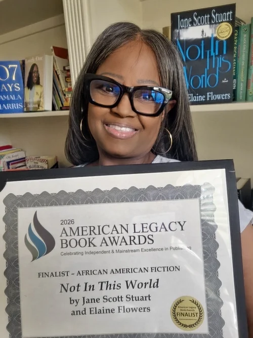 Elaine Flowers holding the 2026 American Legacy Book Awards certificate for Not In This World